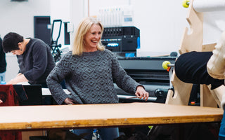 Nancy working on clothing and beanie factory floor at 4T2D clothing brand